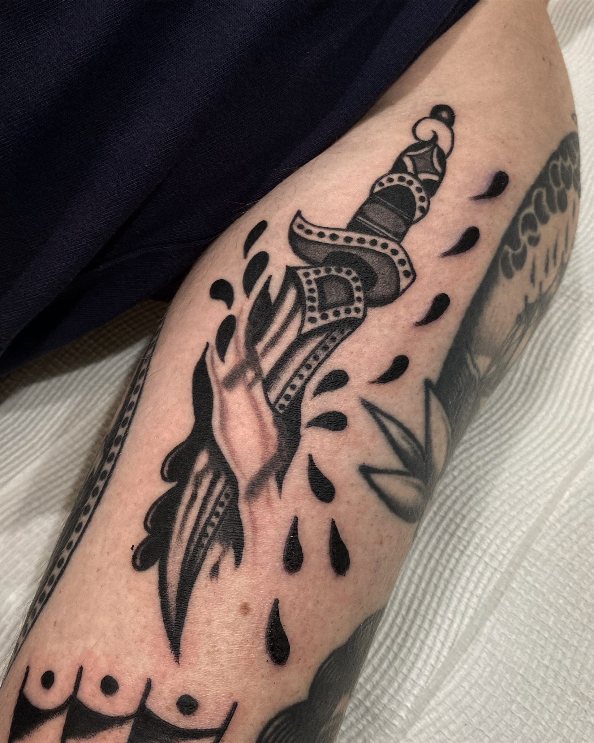 Disembodied gripping an ornate jewelled dagger with droplets falling