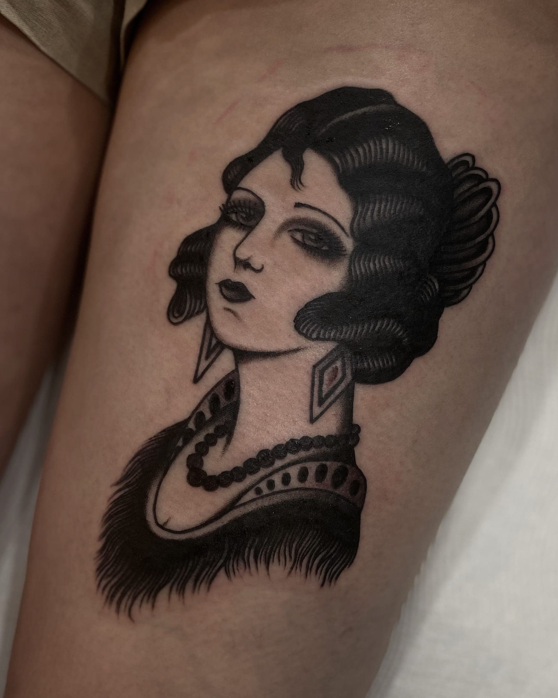 Traditional 1920s flapper portrait with -waved hair, diamond earrings and pearl necklace