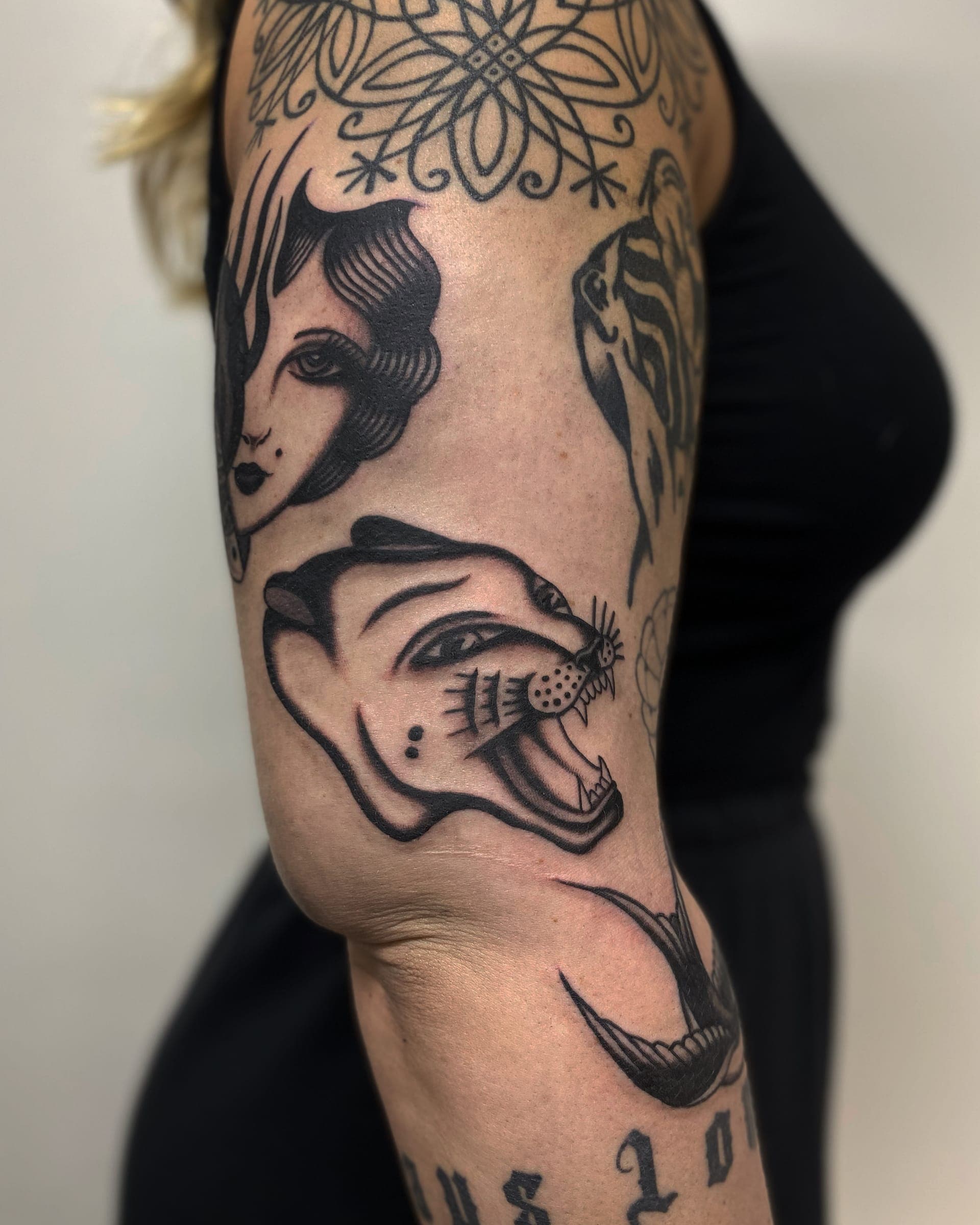 Full back tattoo of a mermaid sat by crystalline rocks under a moon, framed by roses and flowers