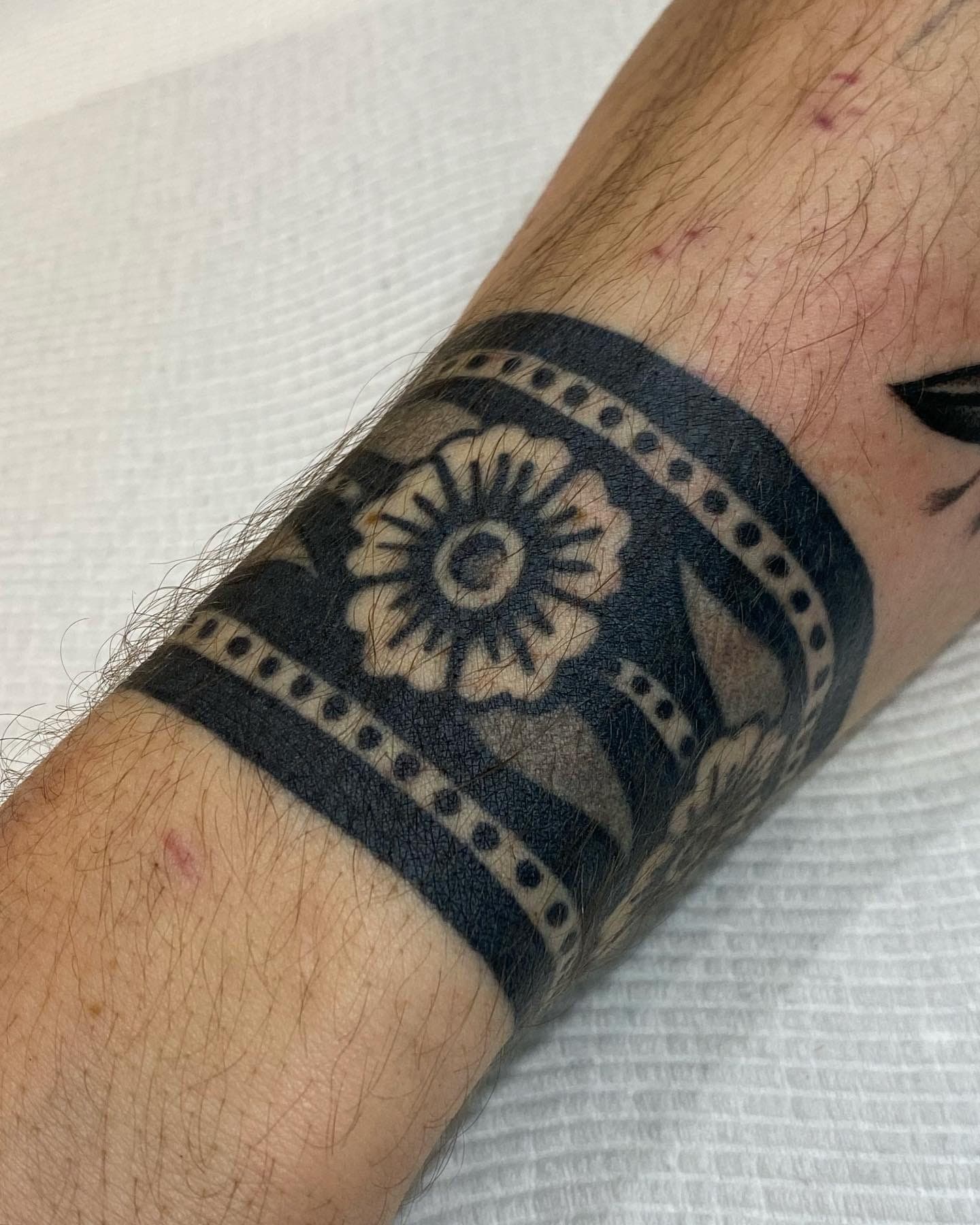 Traditional black ink floral wrapped with dotwork borders