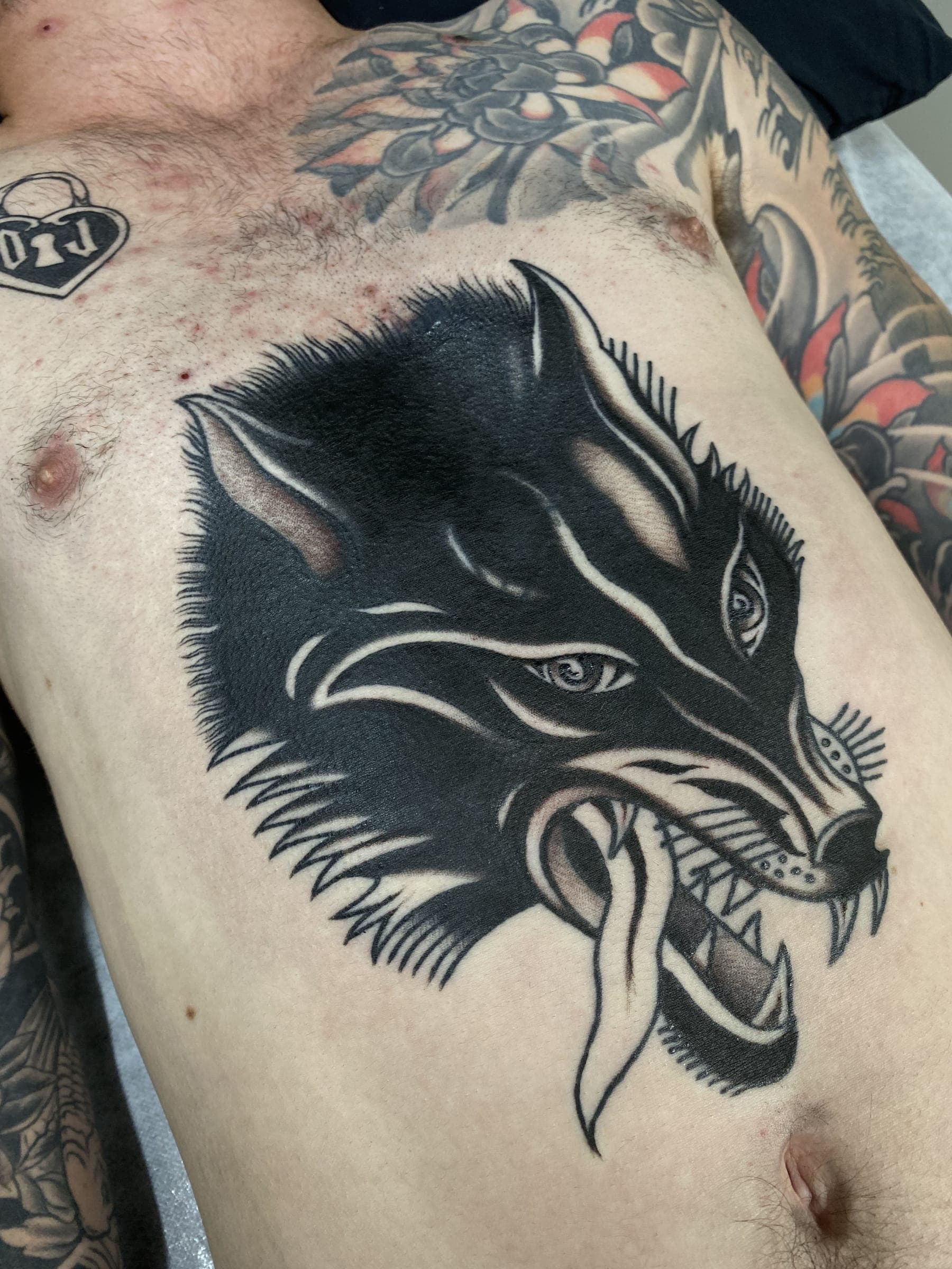 Black traditional wolf head tattoo with long tongue hanging