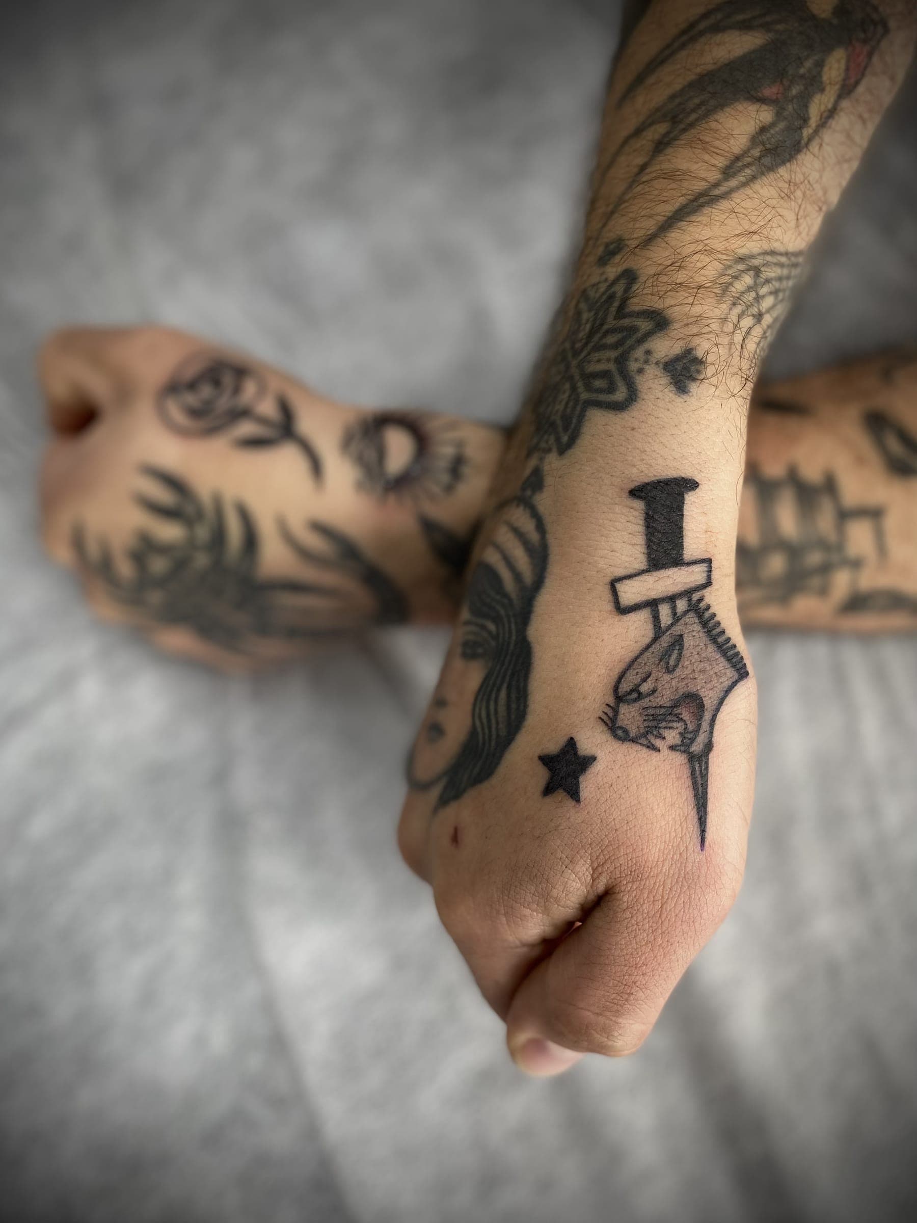 Black traditional panther head tattoo with a dagger and small star