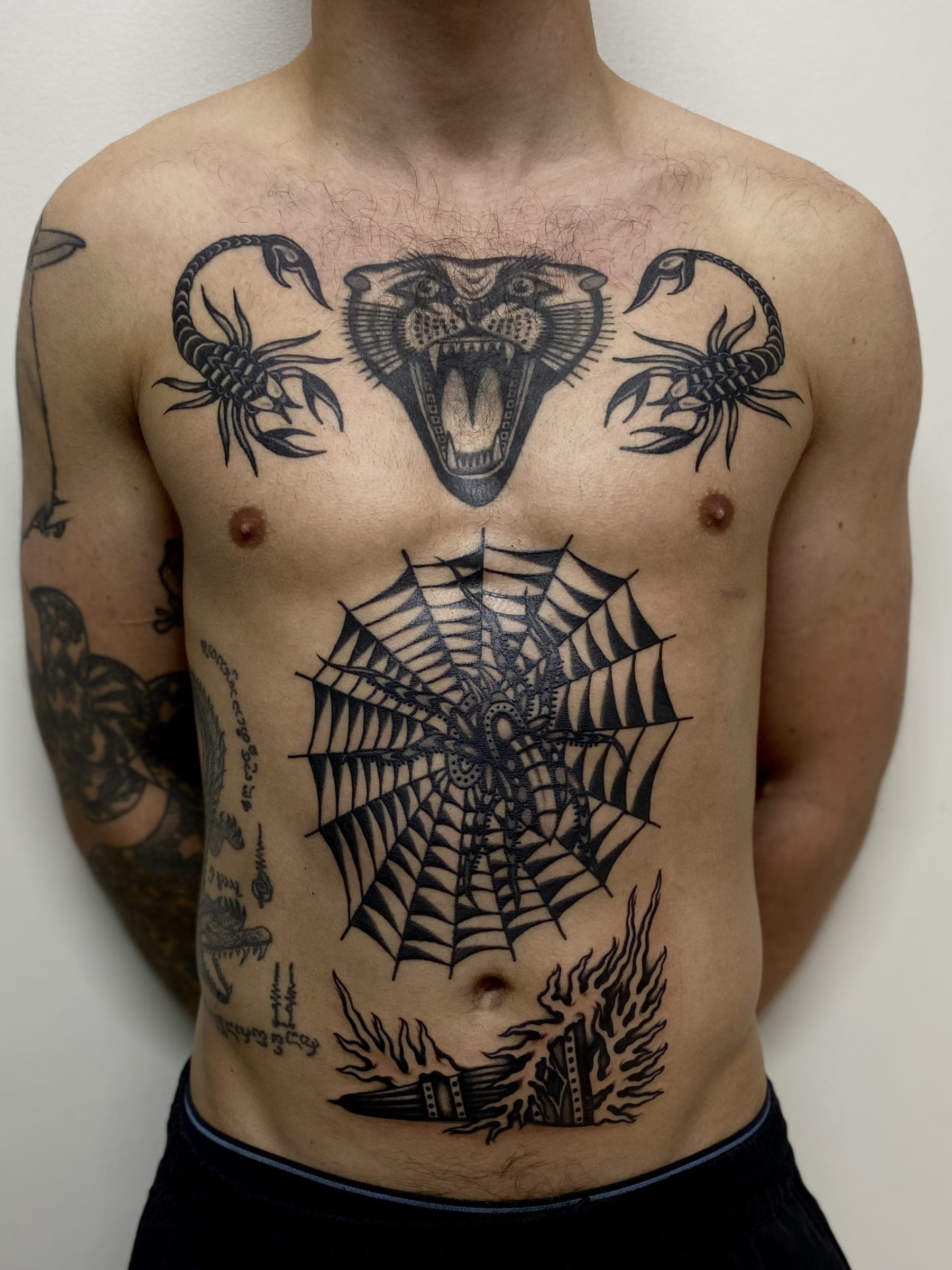 Black traditional panther head with flanking scorpions and a spider web