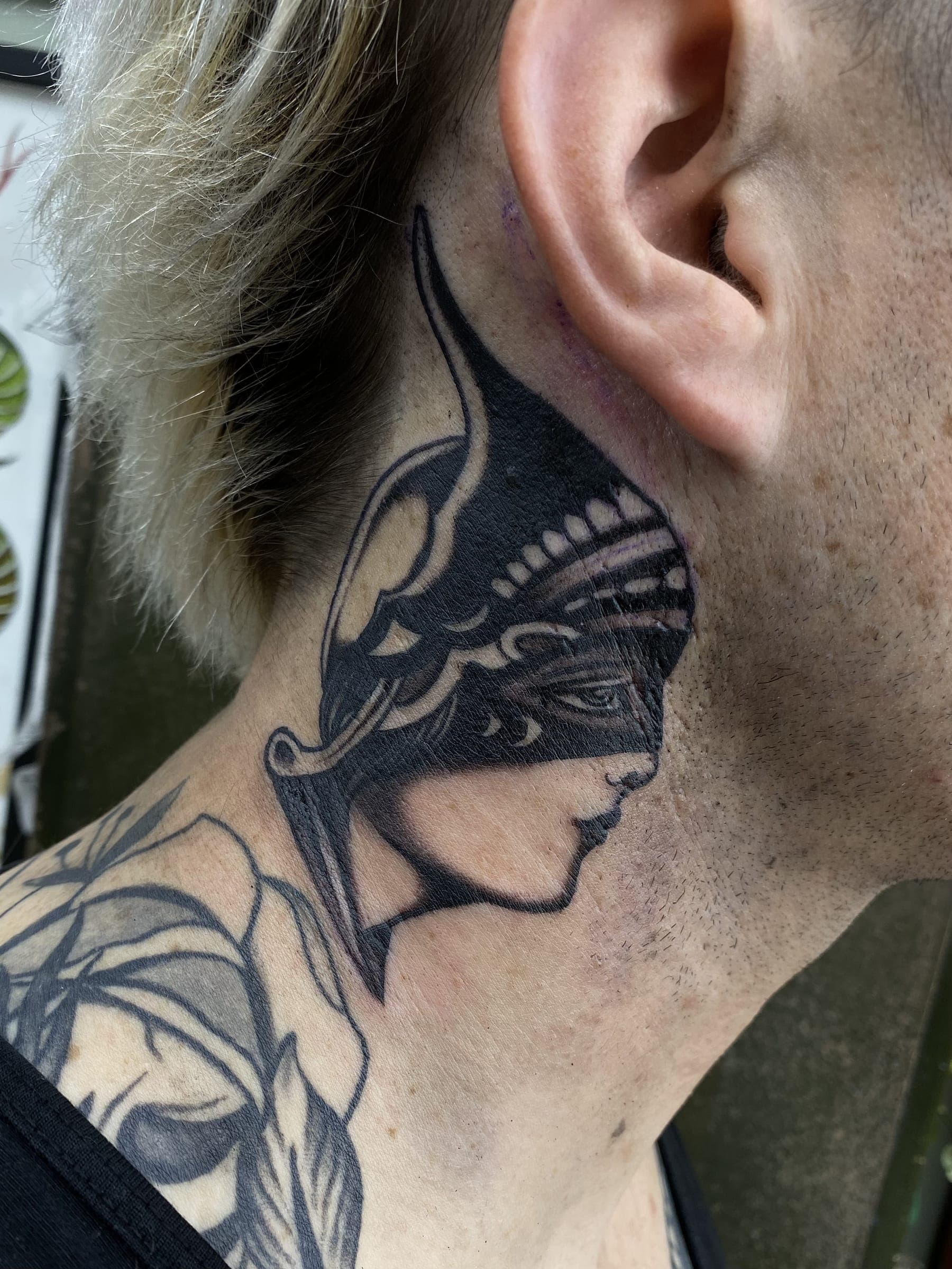 Black traditional Athena profile tattoo with plumed helmet
