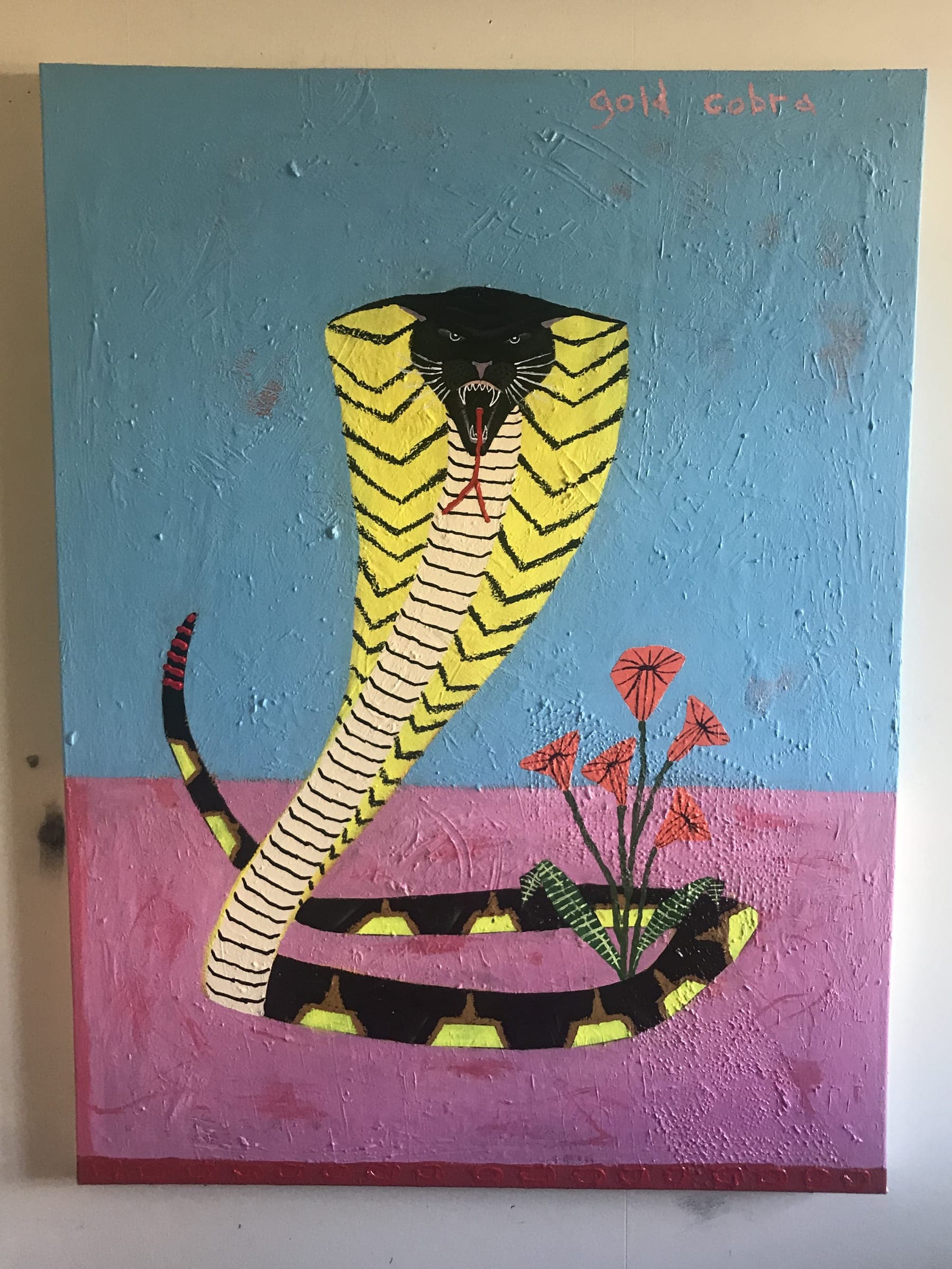 Painted canvas of a yellow cobra rearing over a striped snake and red flowers, labelled Gold Cobra